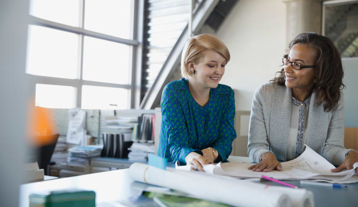 woman mentoring using blueprints