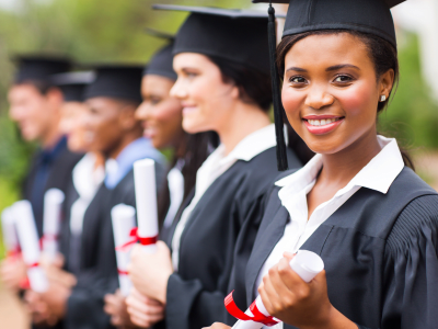 pretty african female college graduate at graduation with classmates