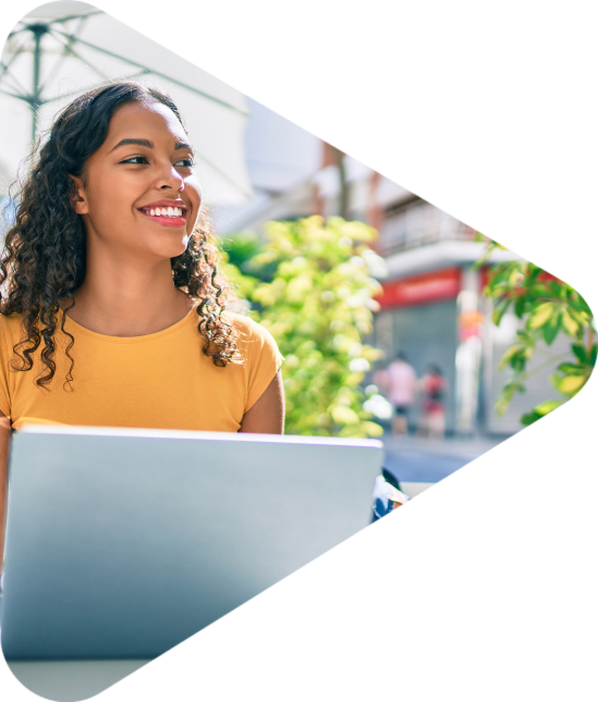 Young african american student girl using laptop sitting on the table at terrace.; Shutterstock ID 1928460668; purchase_order: -; job: -; client: -; other: -