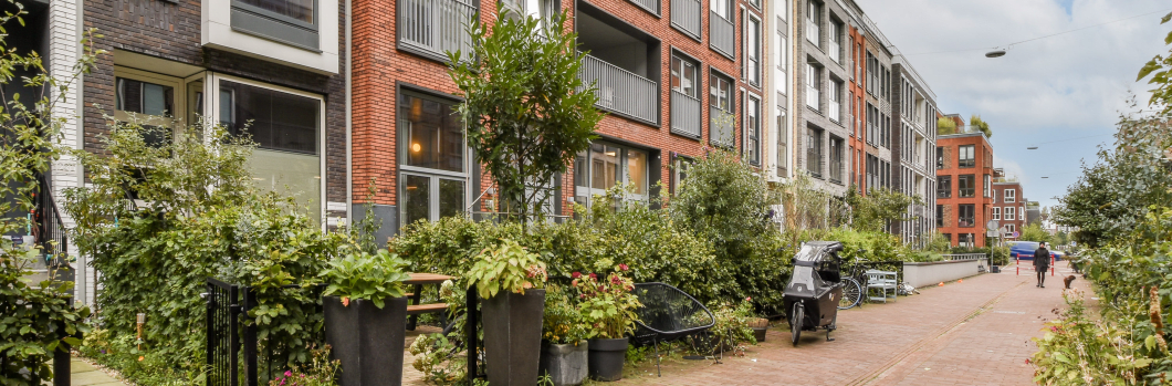 Contemporary residential buildings showcase sleek designs and harmonious layouts, surrounded by lush greenery and walkable paths, emphasizing urban living.