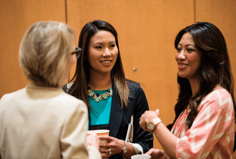Three women talking at CREW networking event