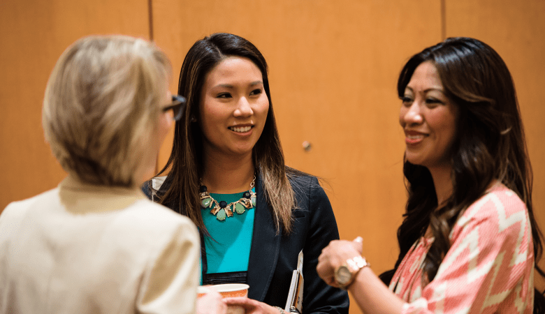 Three women talking at CREW networking event