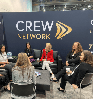 Women connecting at CREW Network ICSC 2022 booth