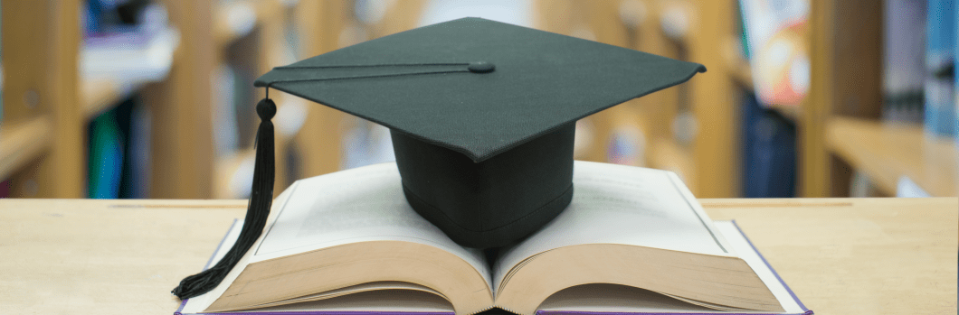graduation cap over open Books on Library room,Education concept