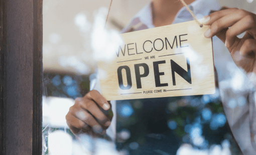 Young startup coffee cafe owener open and welcome customer. New small business owener.